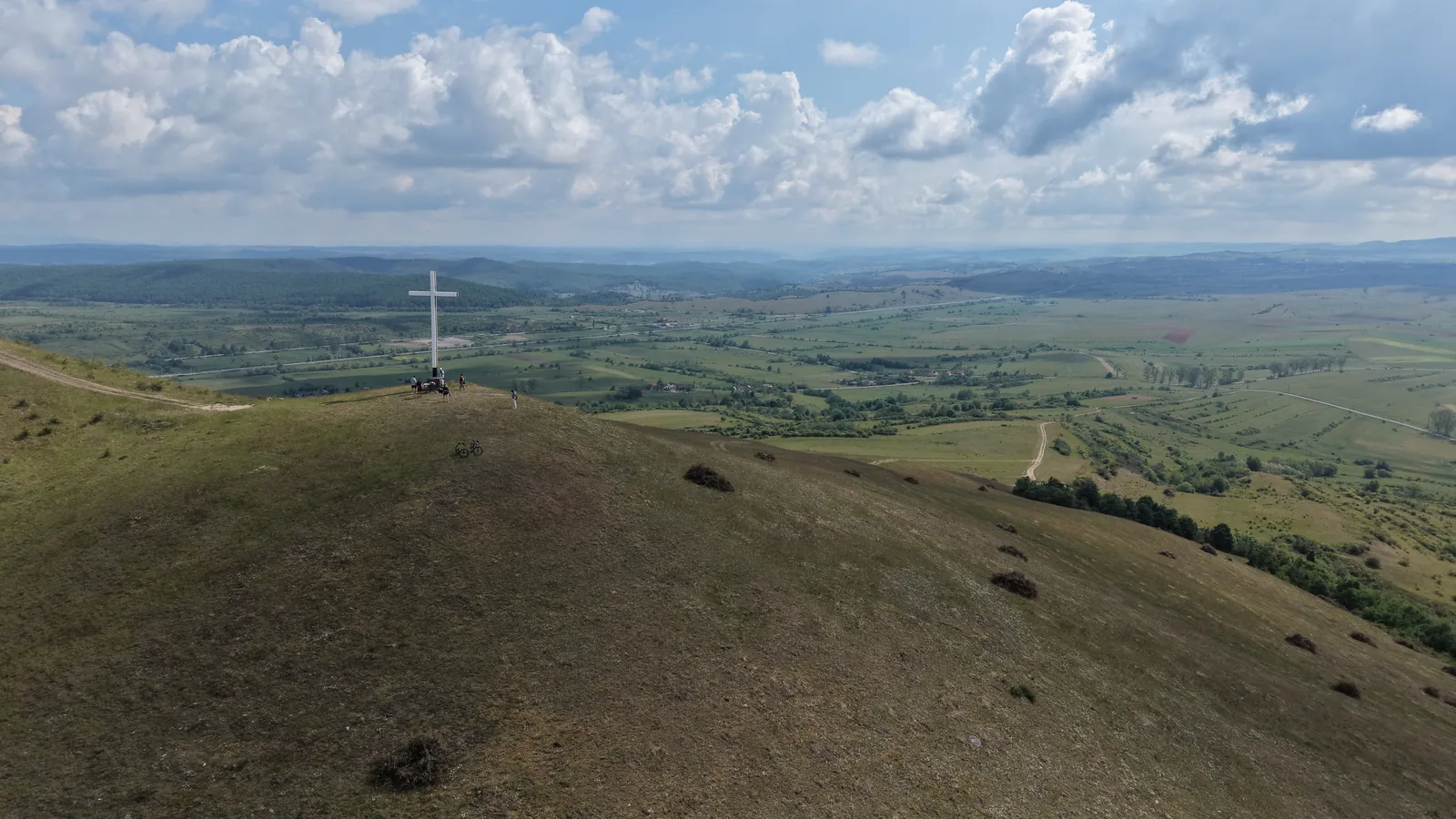 White cross on a ridge — viewpoint over the valley