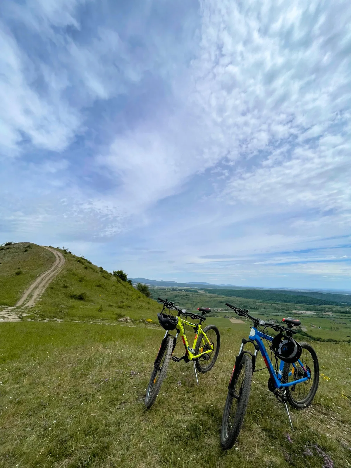 Two bikes on a hill overlooking the valley